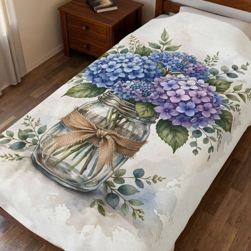 Blue Hydrangeas in a Mason Jar Velveteen Plush Blanket spread on a bed