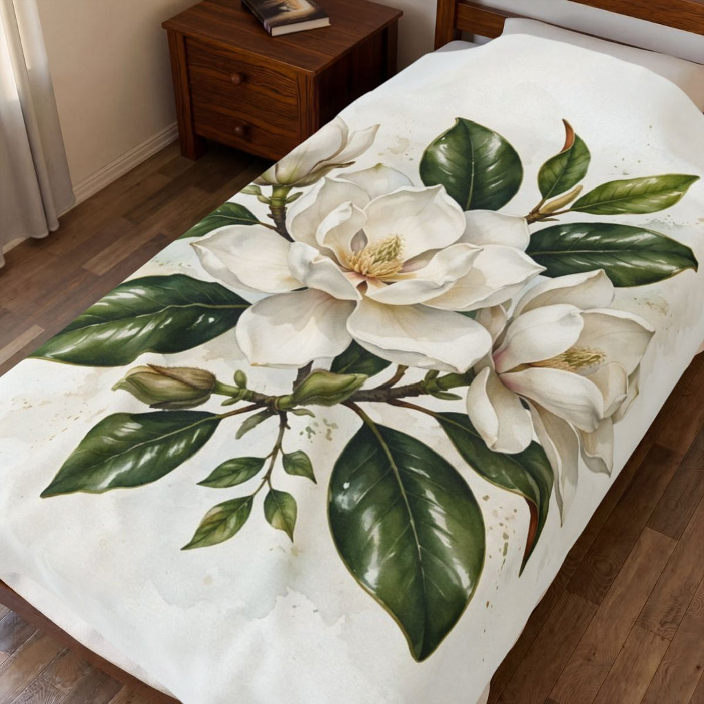 Magnolia Blossoms Velveteen Plush Blanket spread on a bed