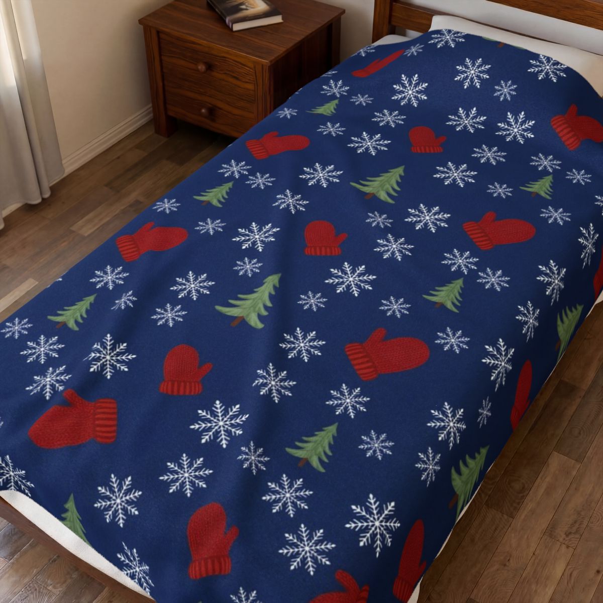 Snowflakes and Mittens Pattern Velveteen Plush Blanket spread on a bed